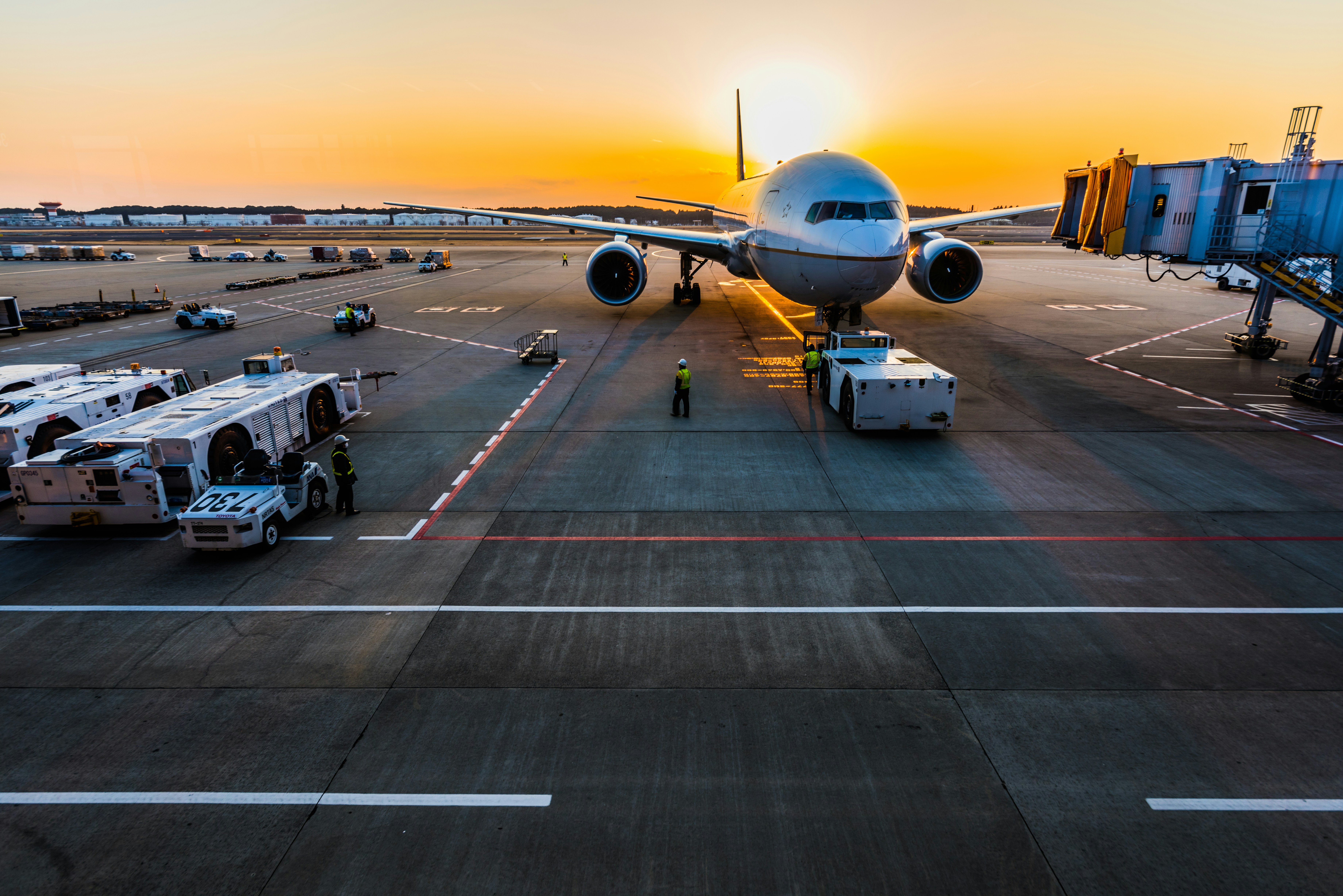 Commercial airliner on runway at golden hour sunset